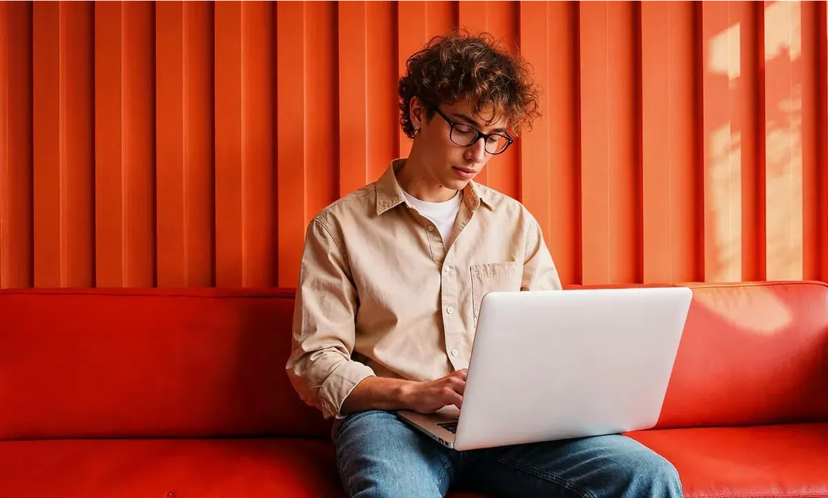 A member of the team working on a laptop