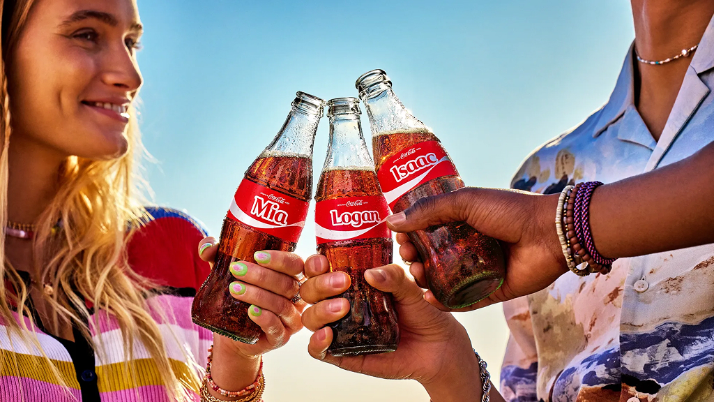 Friends sharing a Coke with their names